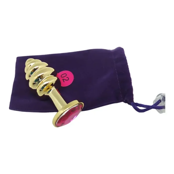 Buttplug in Gold mit Riffeln und pinkfarbenem Kristall